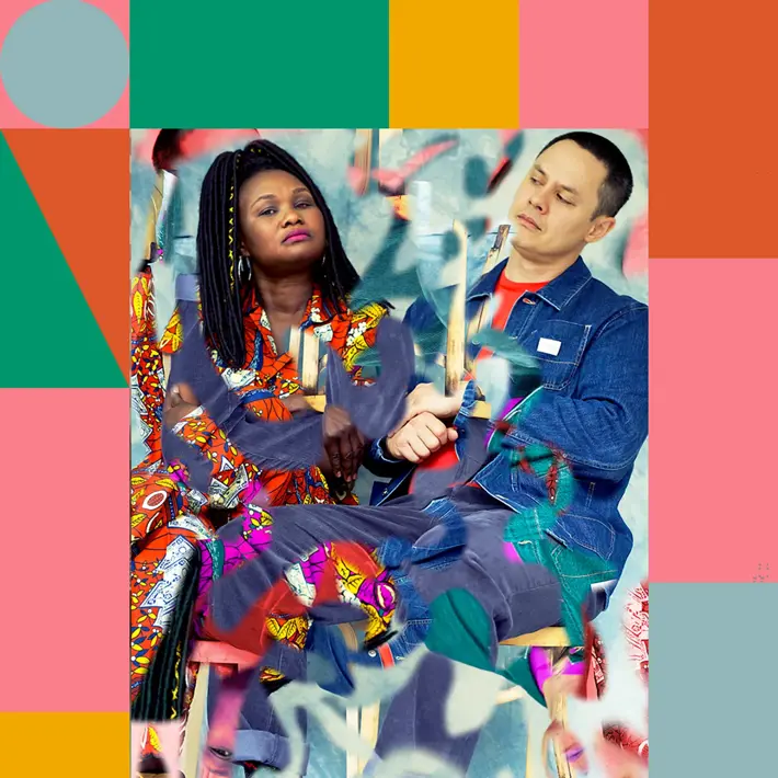 Emma D and ADP from Wrong Way Up sitting down and looking curiously at each other.