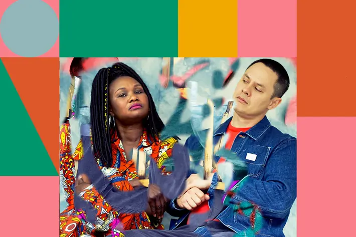 Emma D and ADP from Wrong Way Up sitting down and looking curiously at each other.