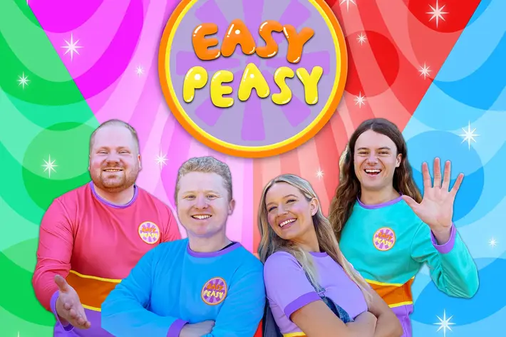An image of the four members of Easy Peasy; Harmony, Jake, Michael and Charlie posed in front of a brightly coloured background.