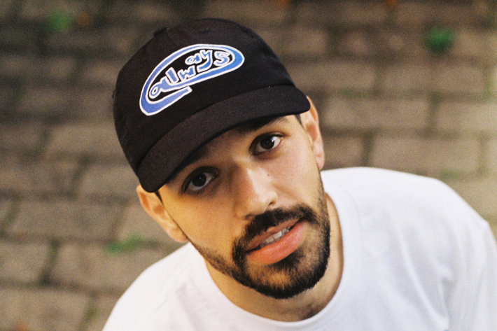 Name UL star up directly to the camera wearing a white t-shirt and a black cap that reads 'always' on the front