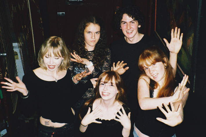 Mansplainers (Libby, Lucy, Matilda, Lily and James) posing with arms out at the Gem