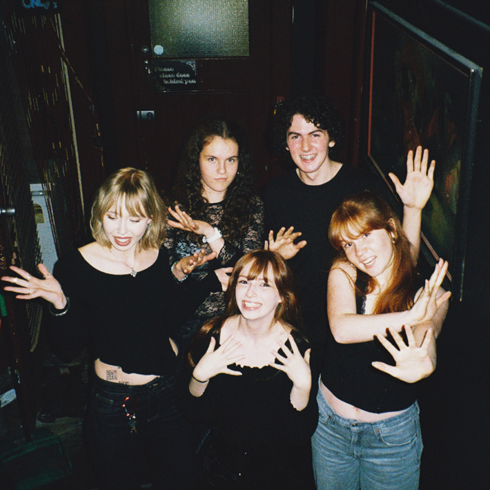 Mansplainers (Libby, Lucy, Matilda, Lily and James) posing with arms out at the Gem